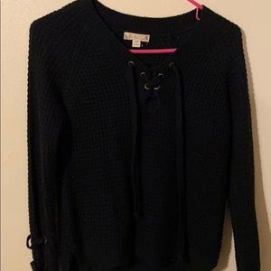 Black sweater with string detail and the neck